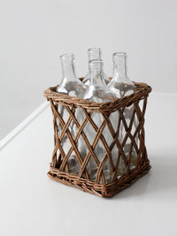 vintage wicker bottle basket with glass bottles