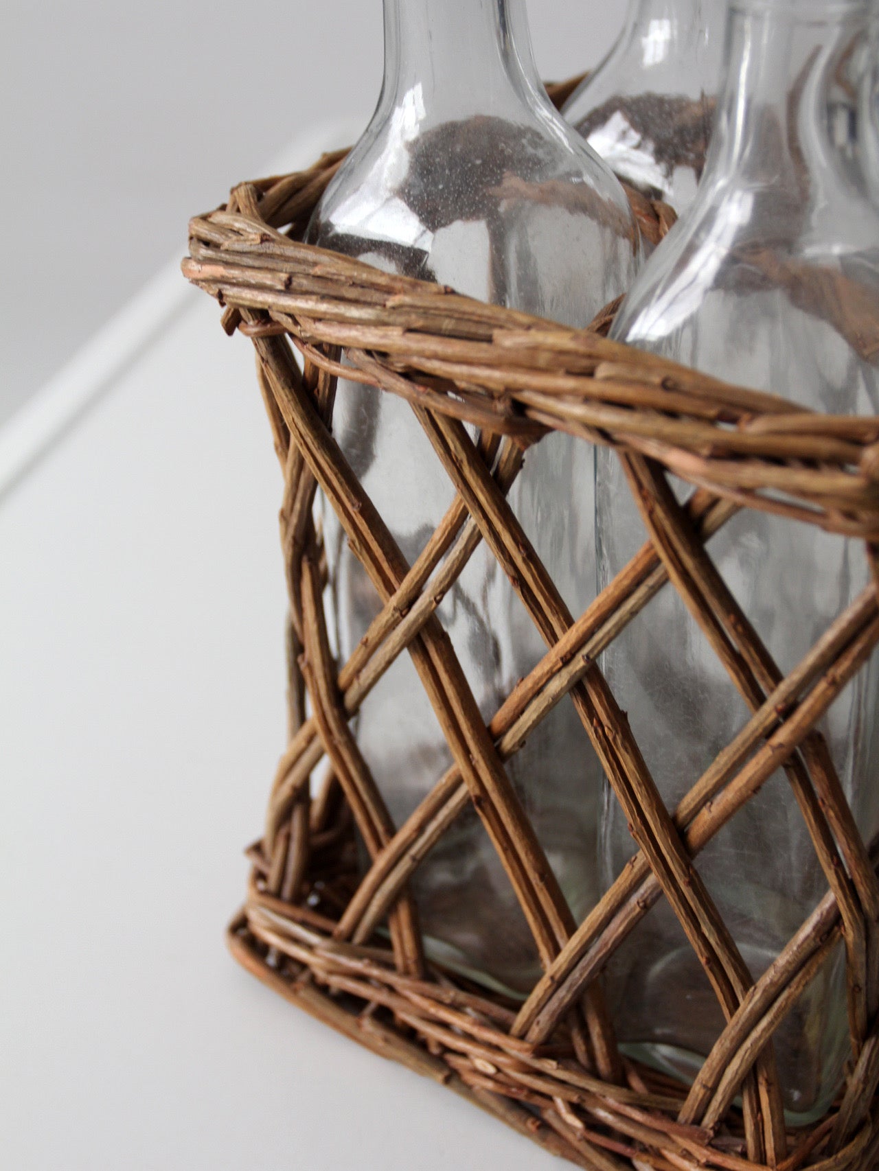 vintage wicker bottle basket with glass bottles