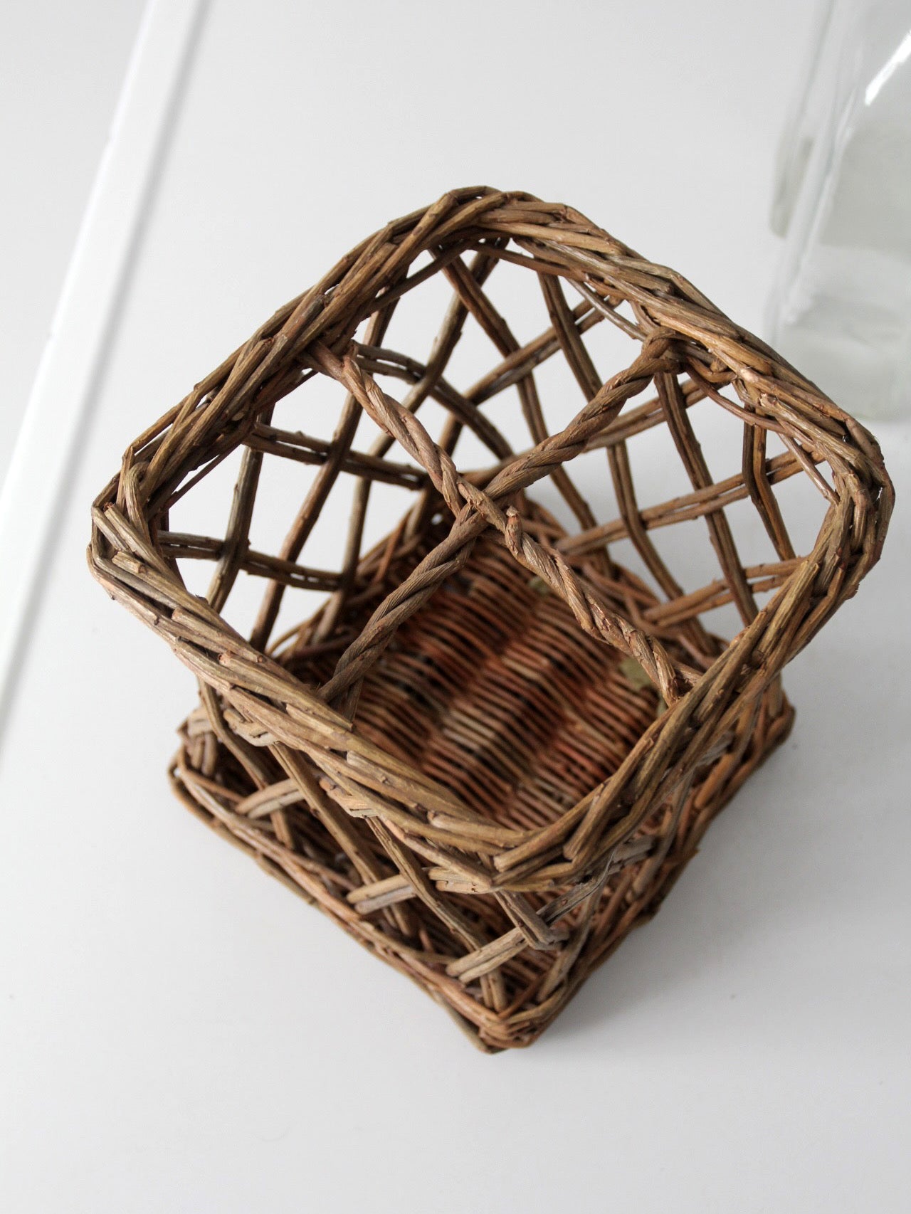 vintage wicker bottle basket with glass bottles