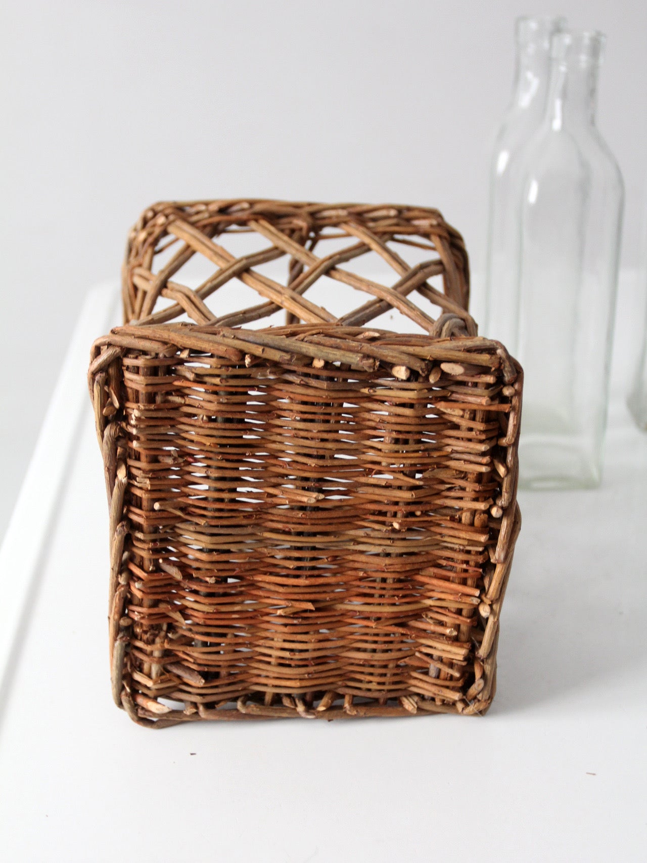 vintage wicker bottle basket with glass bottles