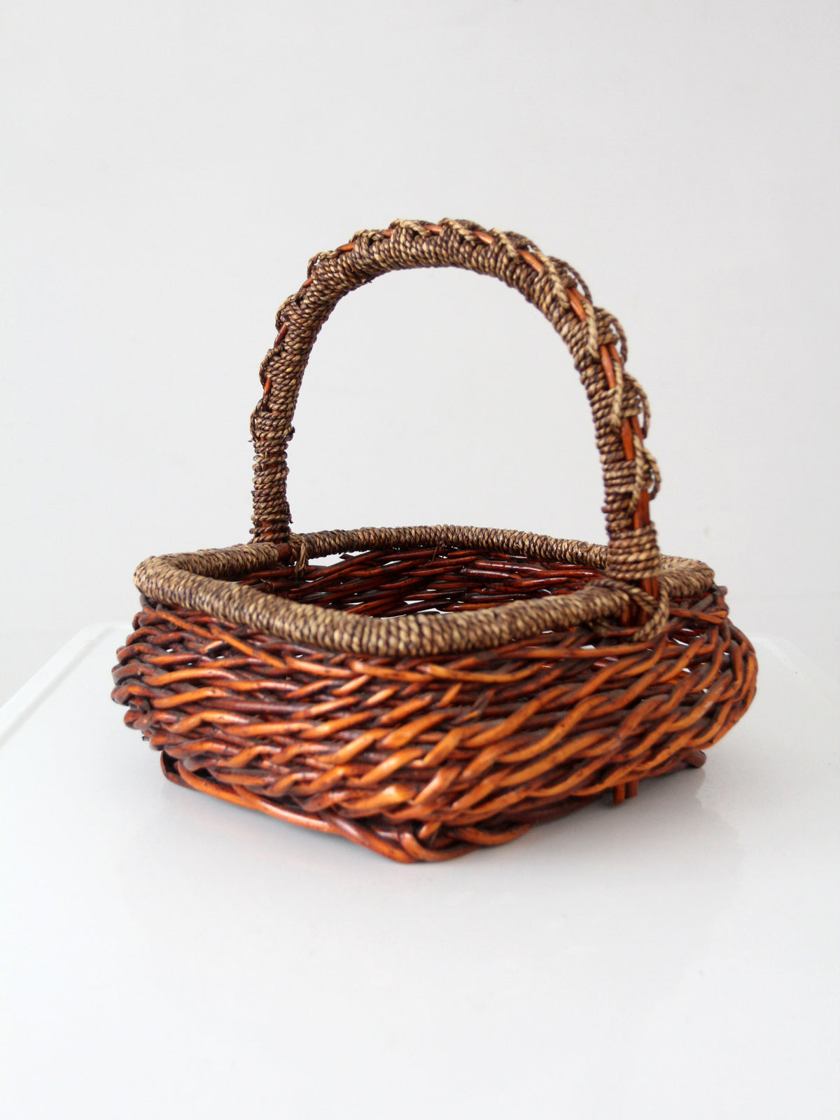 vintage woven willow basket with wrapped arched handle