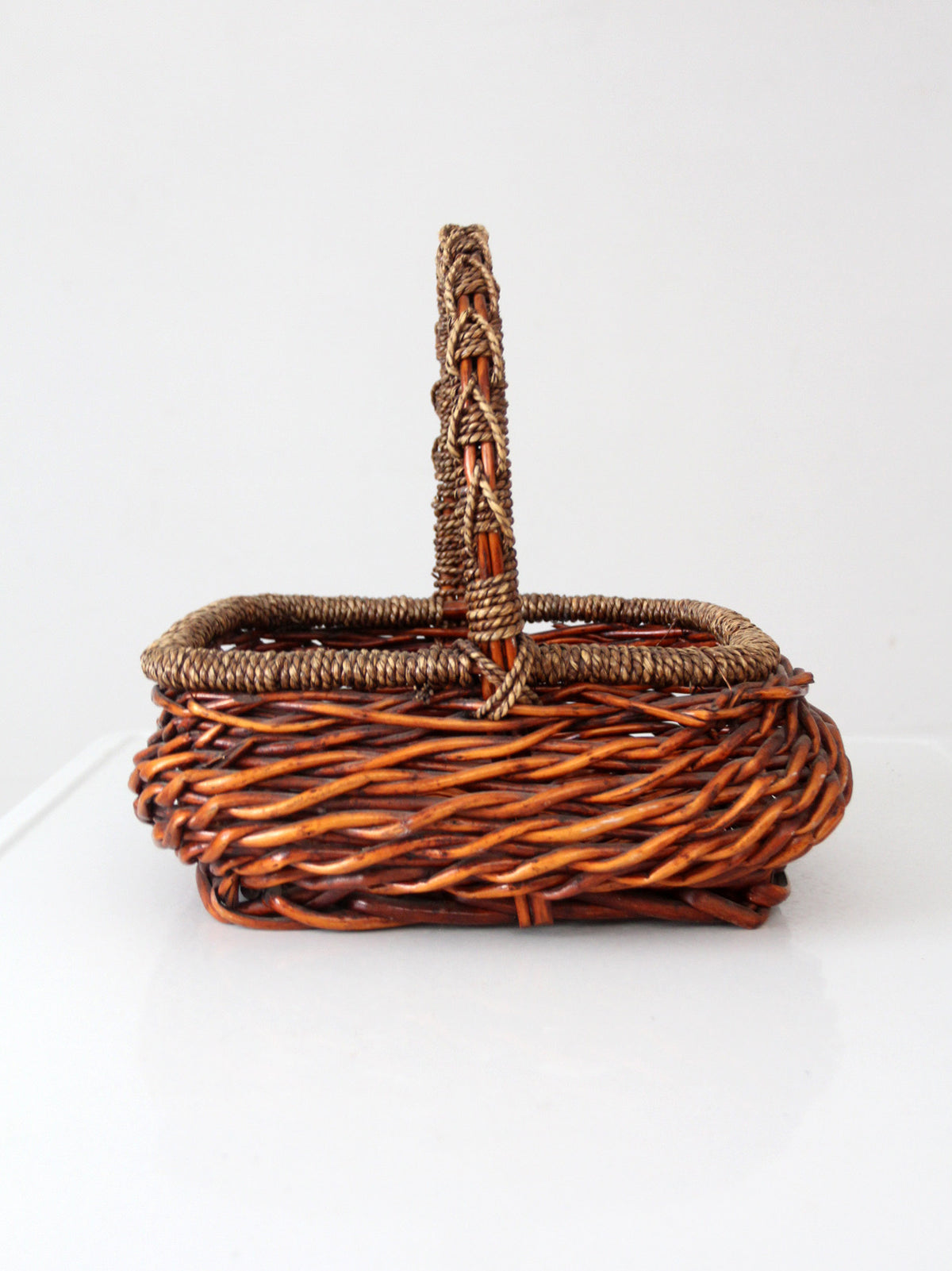 vintage woven willow basket with wrapped arched handle