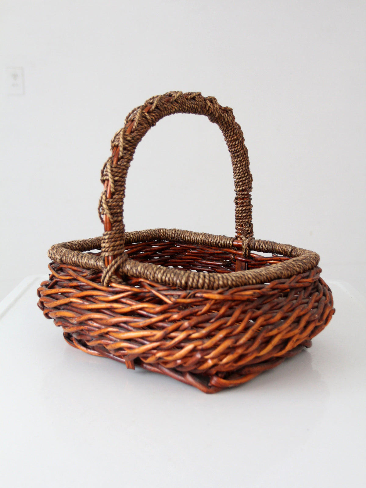 vintage woven willow basket with wrapped arched handle