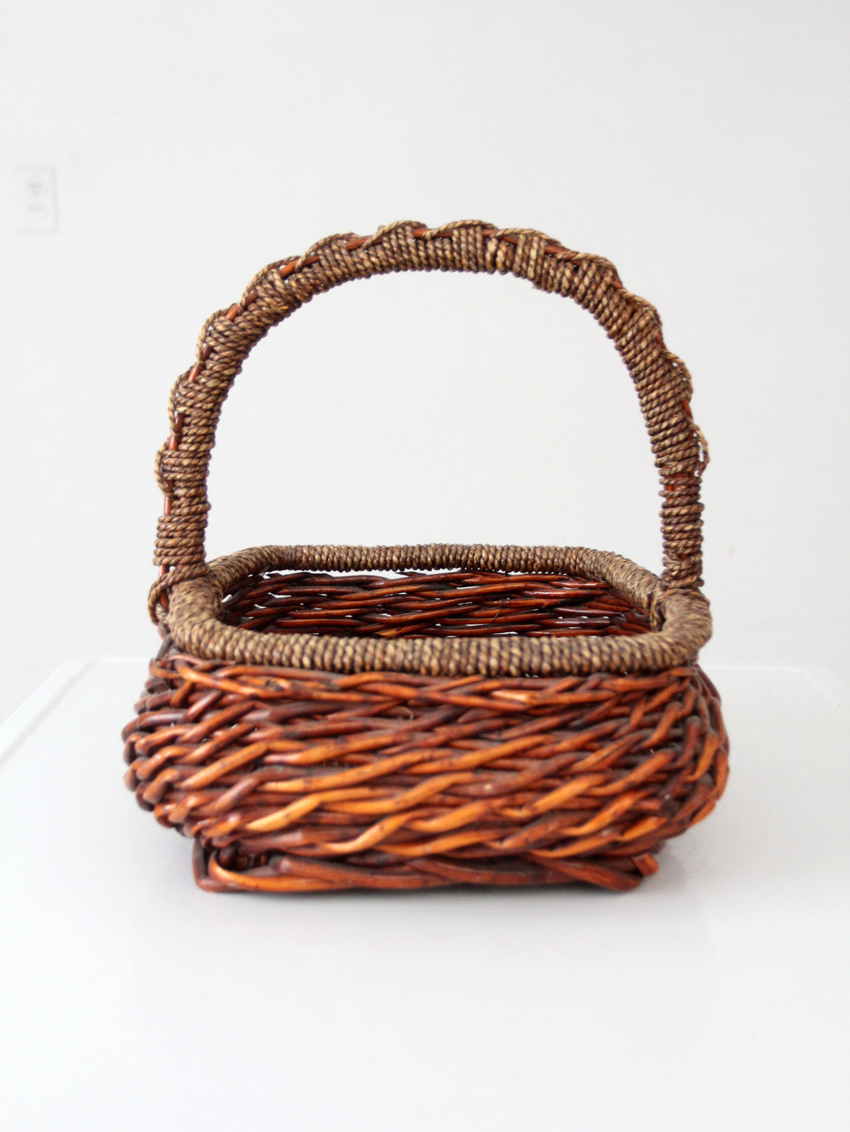 vintage woven willow basket with wrapped arched handle