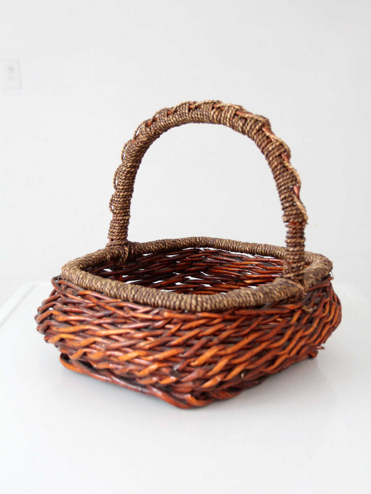vintage woven willow basket with wrapped arched handle
