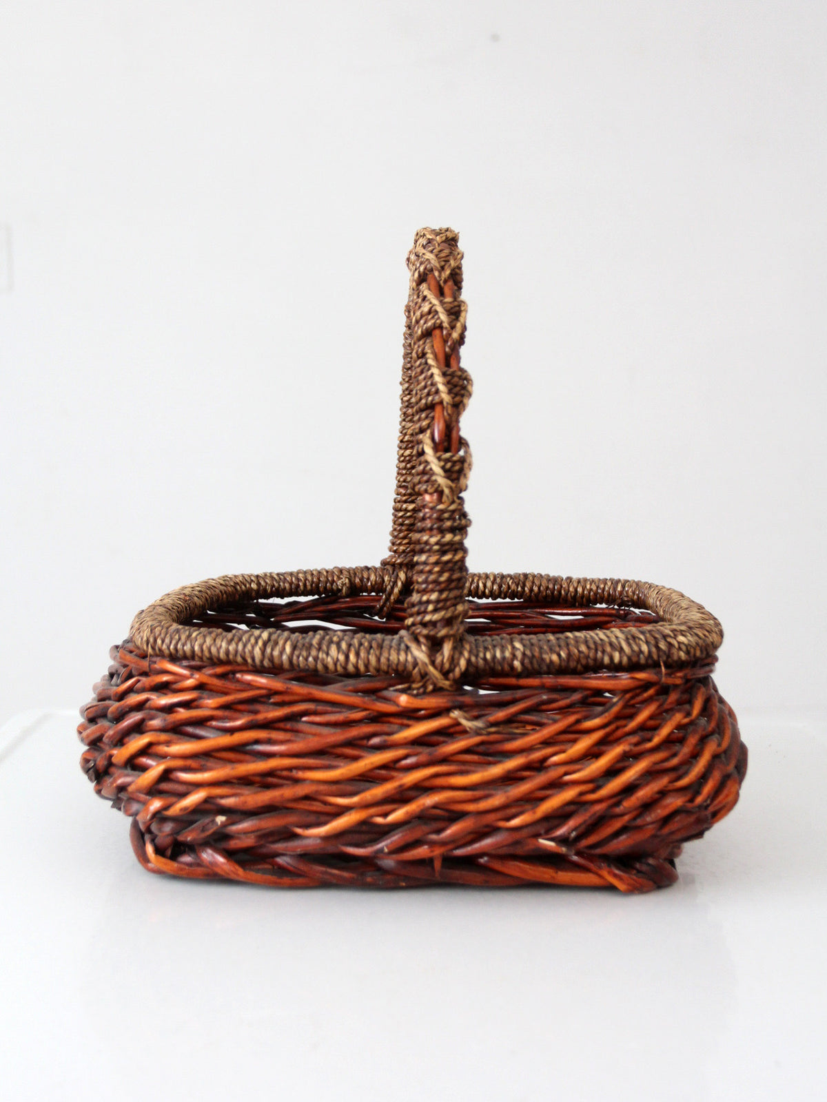 vintage woven willow basket with wrapped arched handle