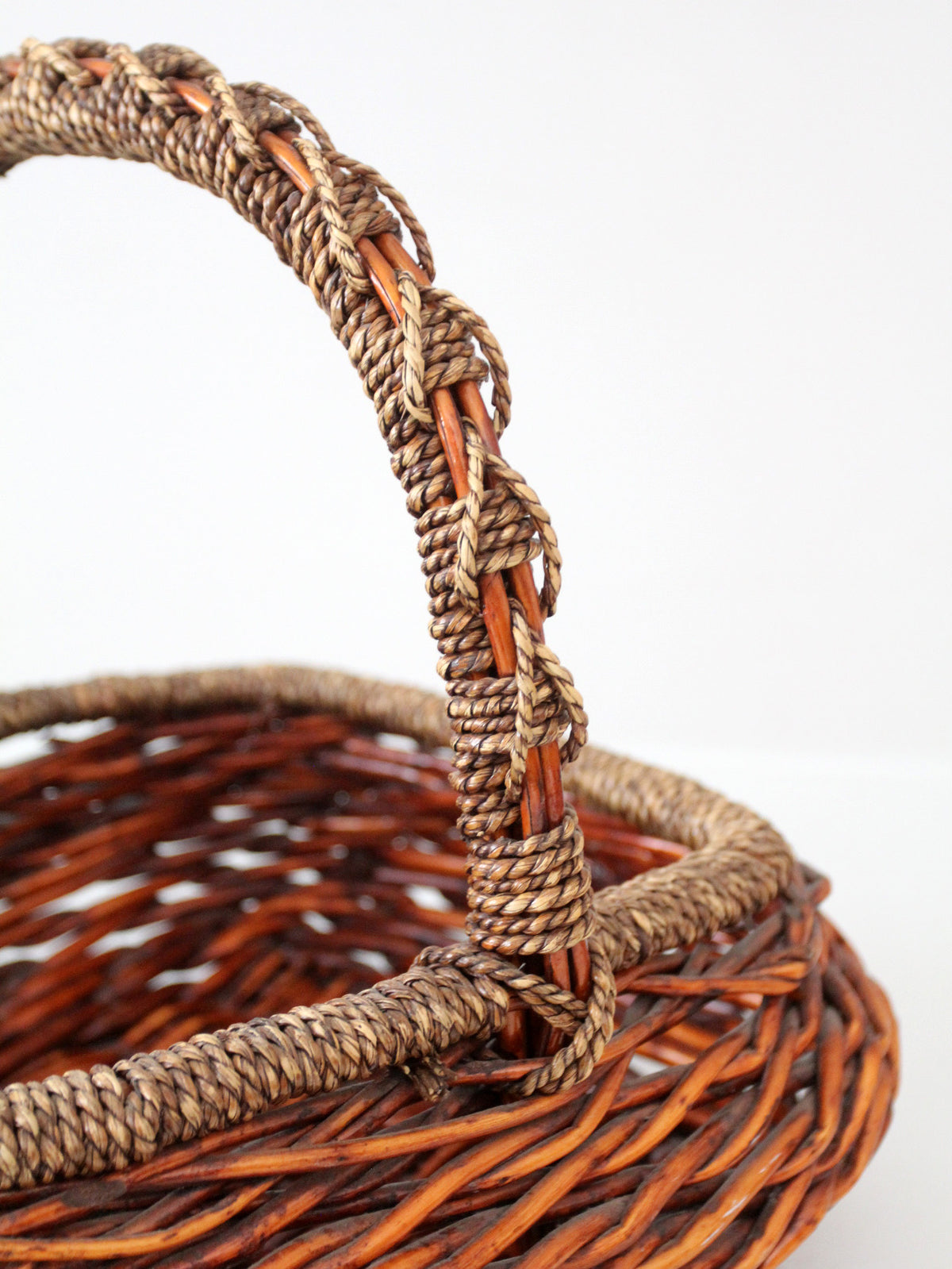 vintage woven willow basket with wrapped arched handle