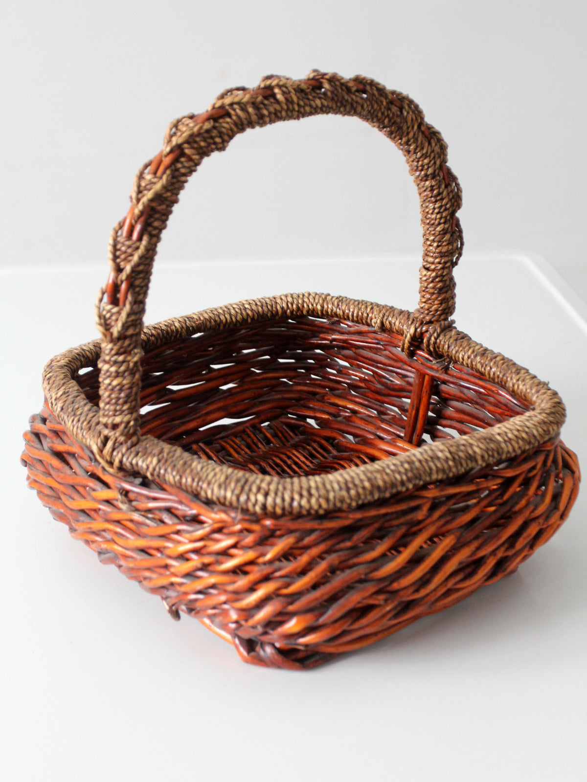vintage woven willow basket with wrapped arched handle