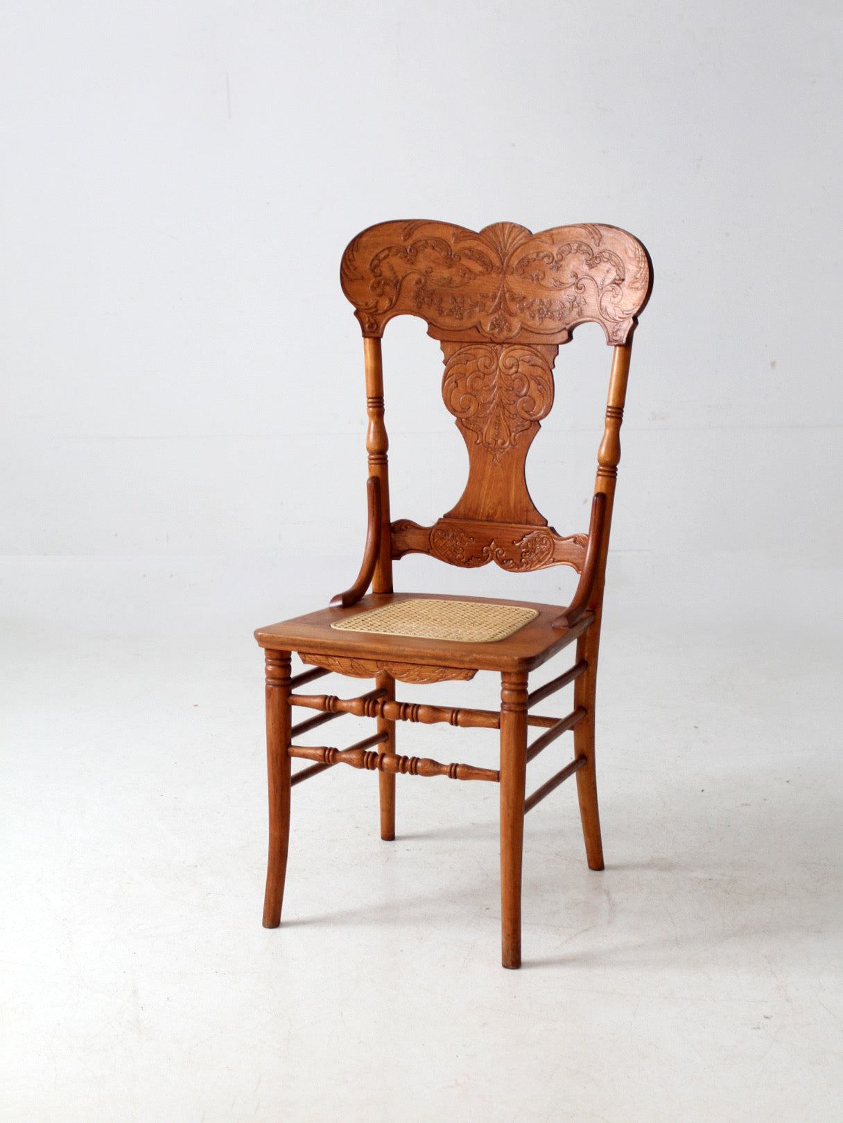 antique pressed back oak chair with cane seat