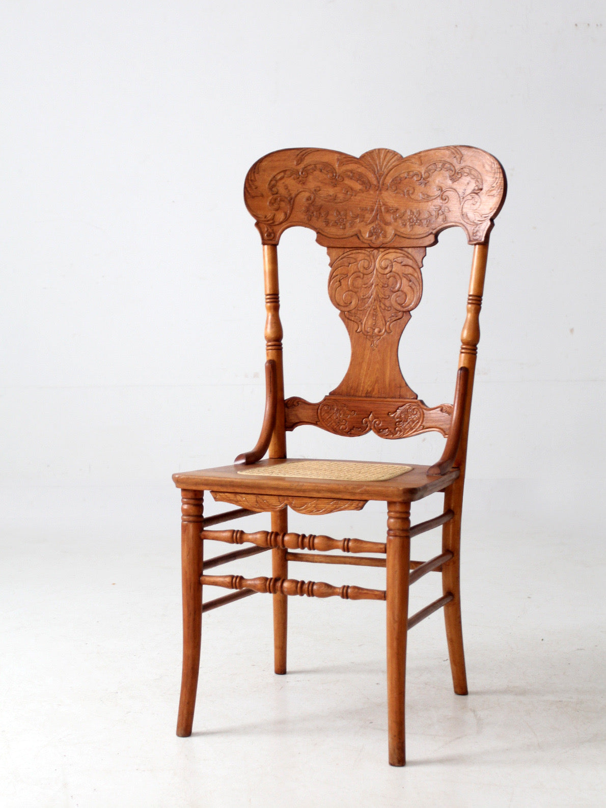 antique pressed back oak chair with cane seat
