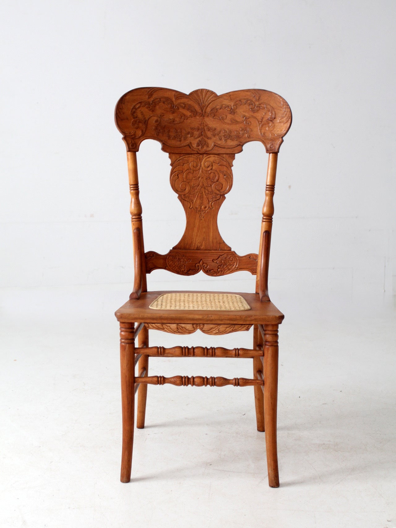 antique pressed back oak chair with cane seat