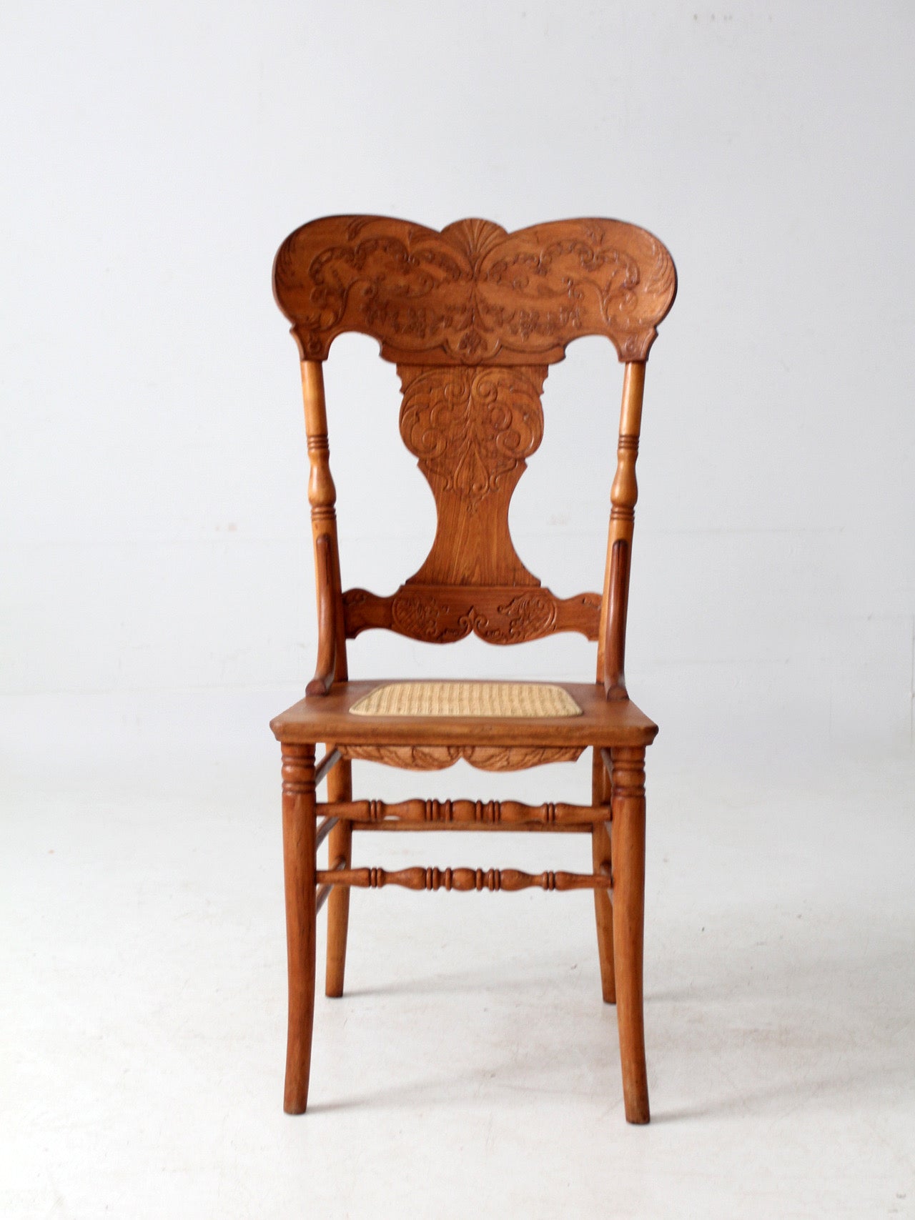 antique pressed back oak chair with cane seat