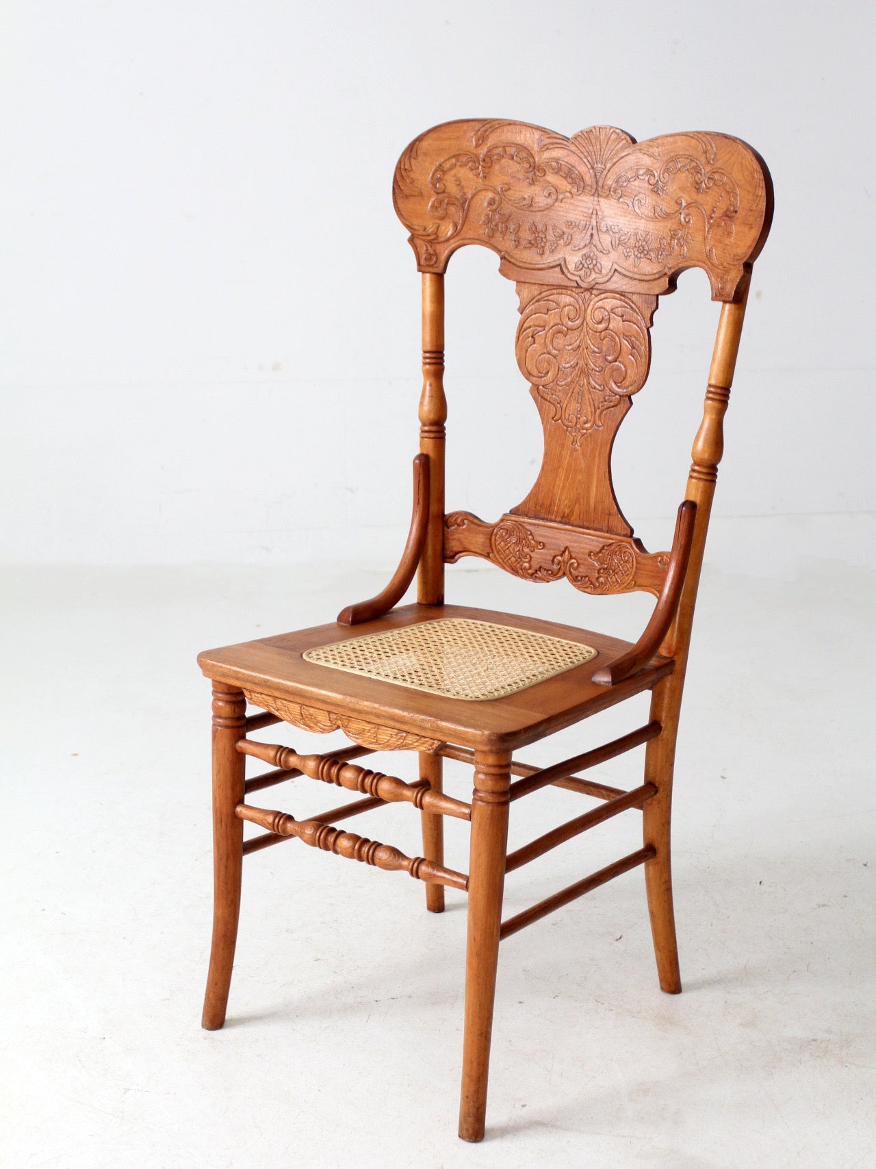antique pressed back oak chair with cane seat