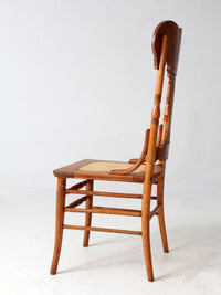 antique pressed back oak chair with cane seat