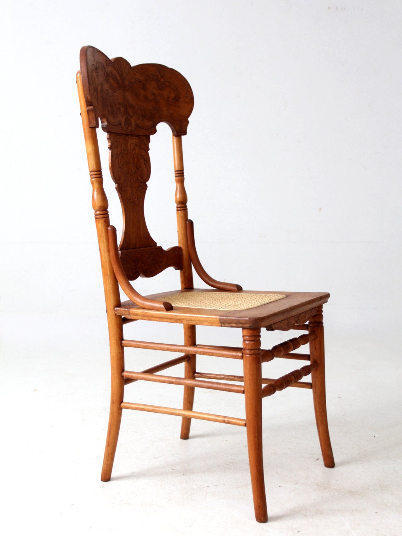 antique pressed back oak chair with cane seat