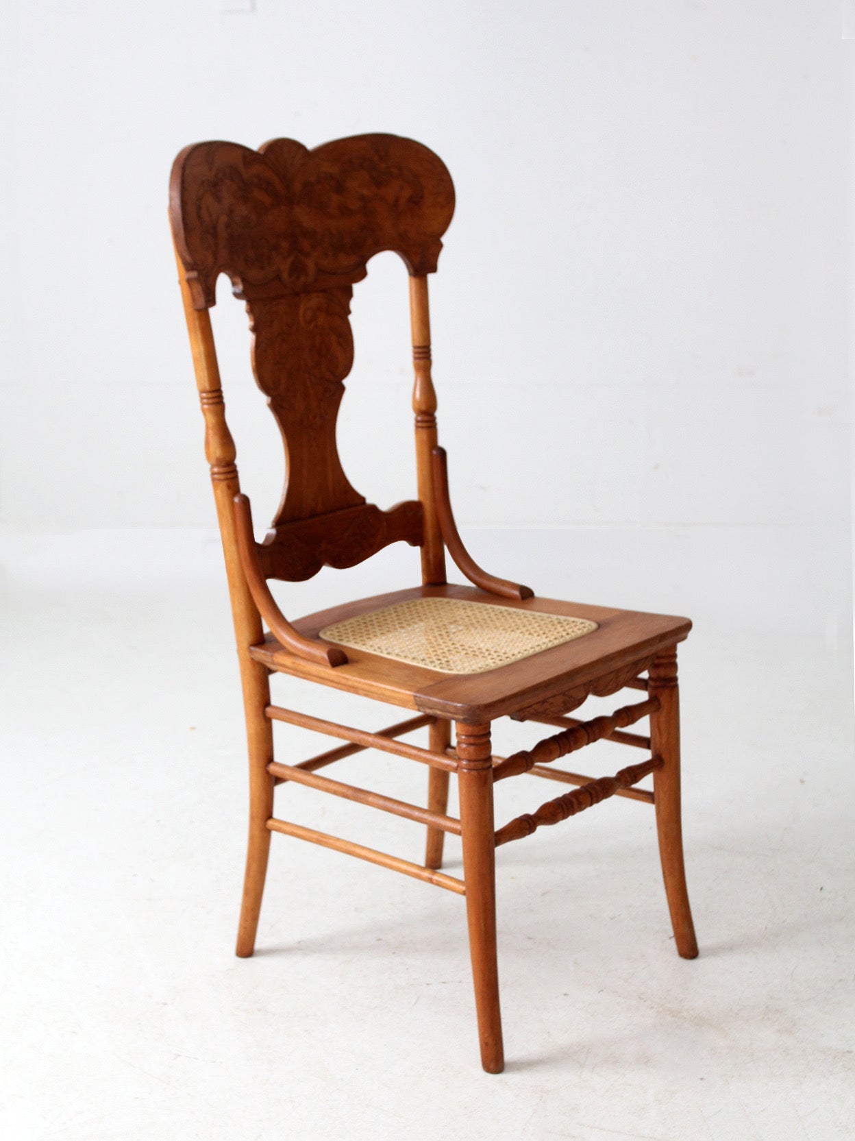 antique pressed back oak chair with cane seat