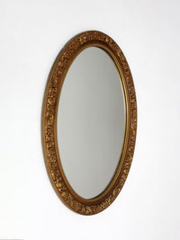 mid-century oval gilt wall mirror