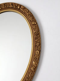 mid-century oval gilt wall mirror