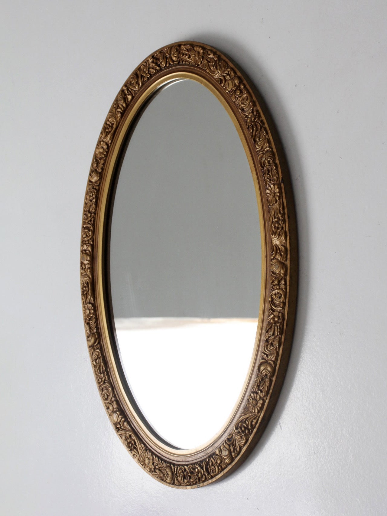 mid-century oval gilt wall mirror