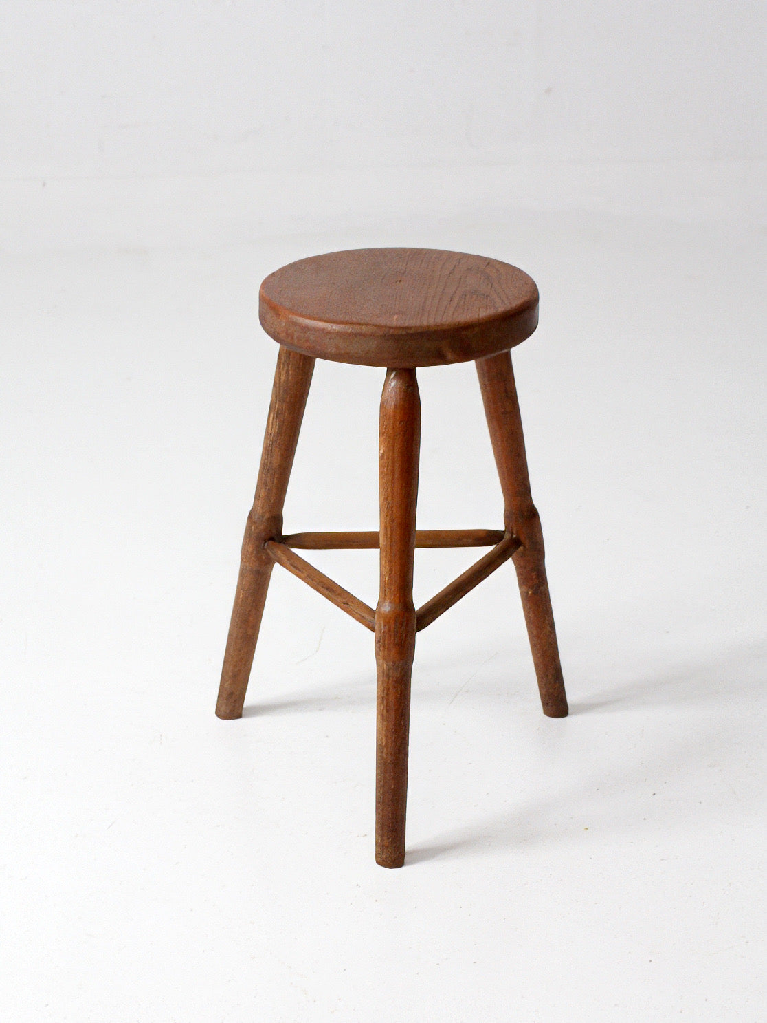antique primitive three-legged wooden stool