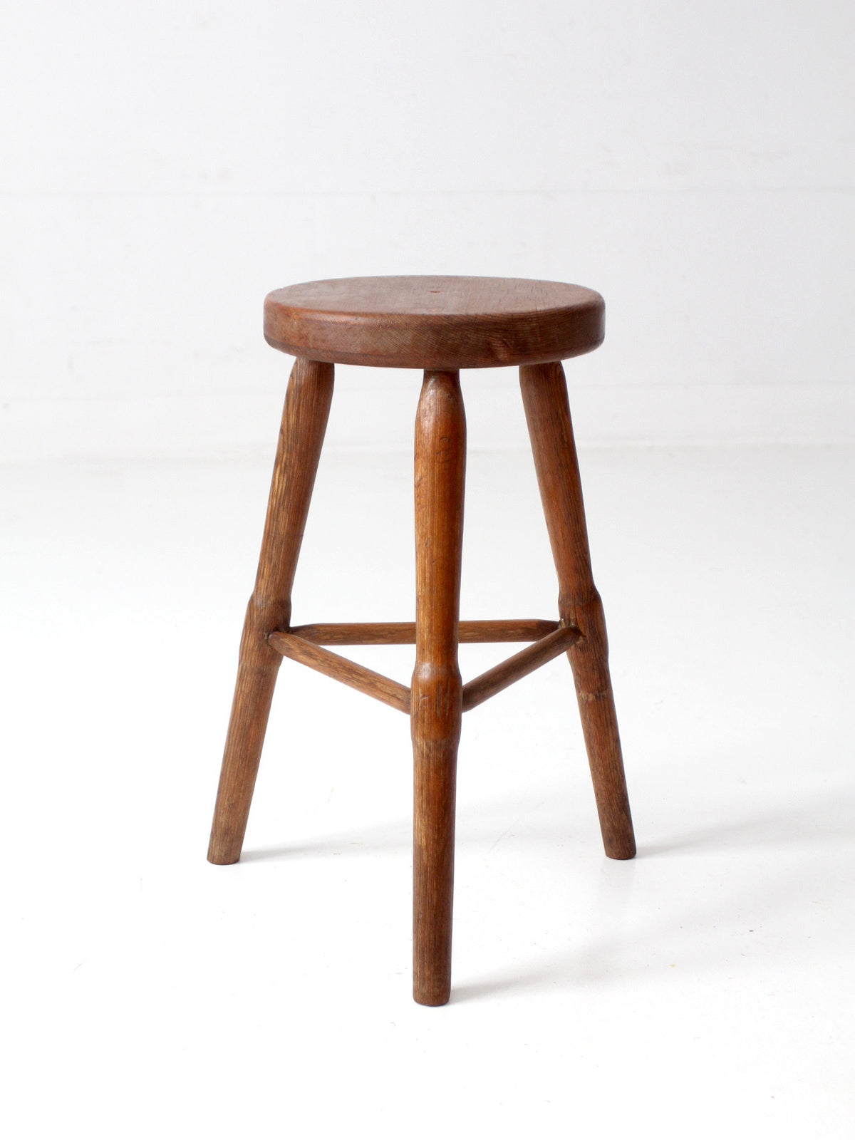 antique primitive three-legged wooden stool