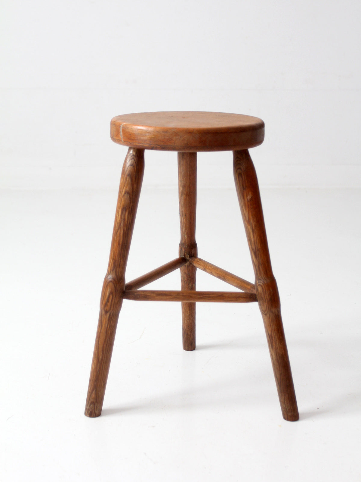 antique primitive three-legged wooden stool