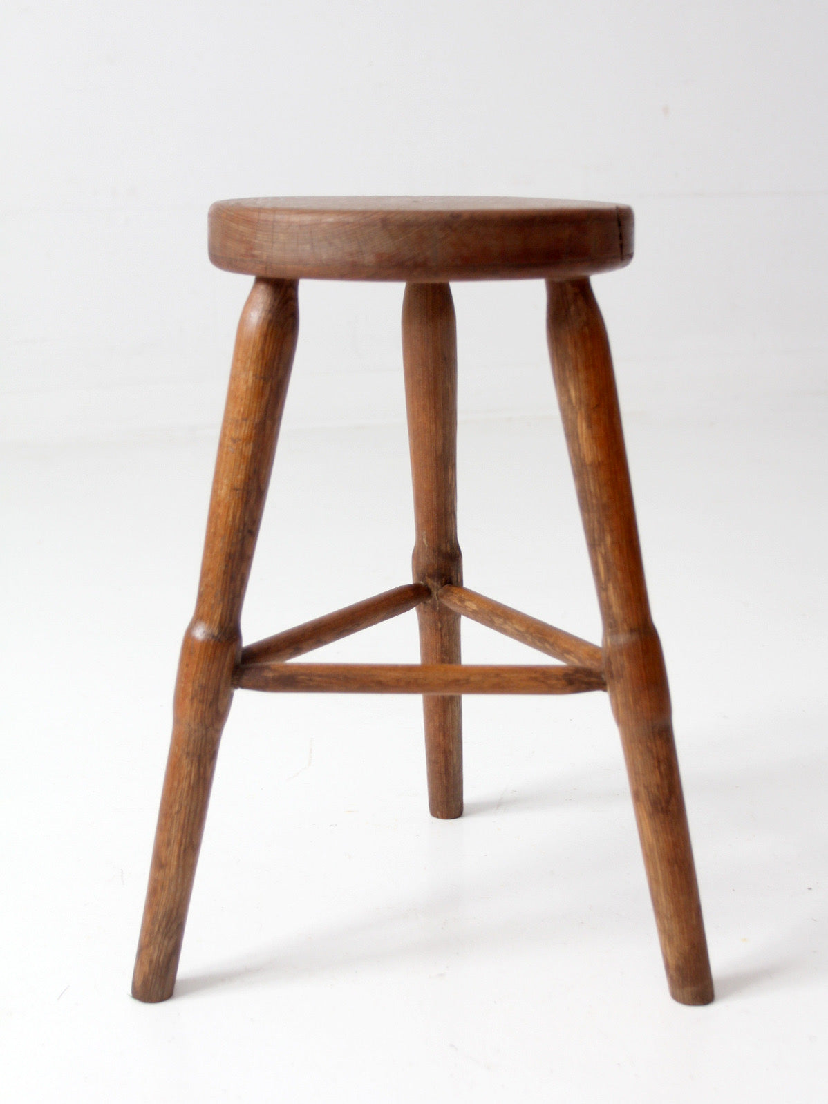 antique primitive three-legged wooden stool