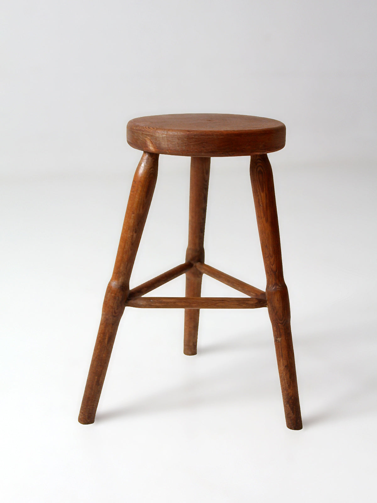 antique primitive three-legged wooden stool