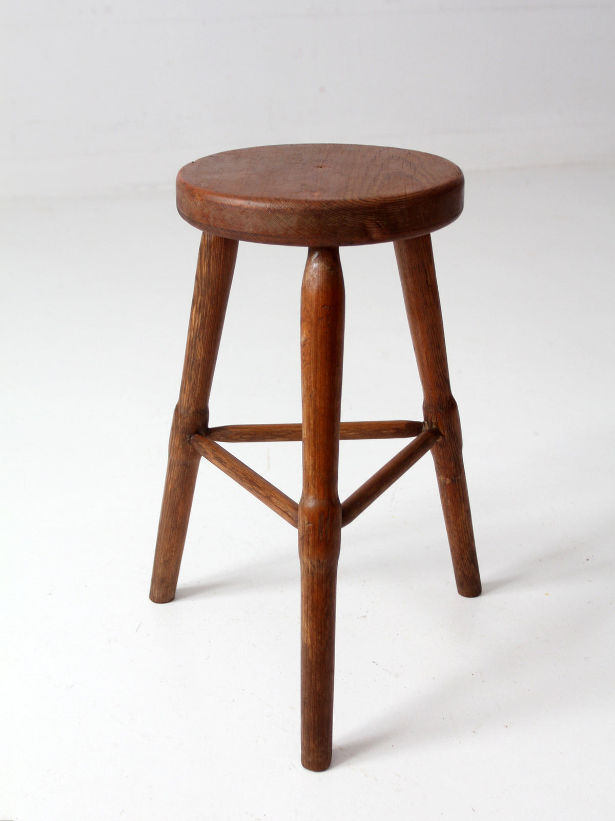 antique primitive three-legged wooden stool