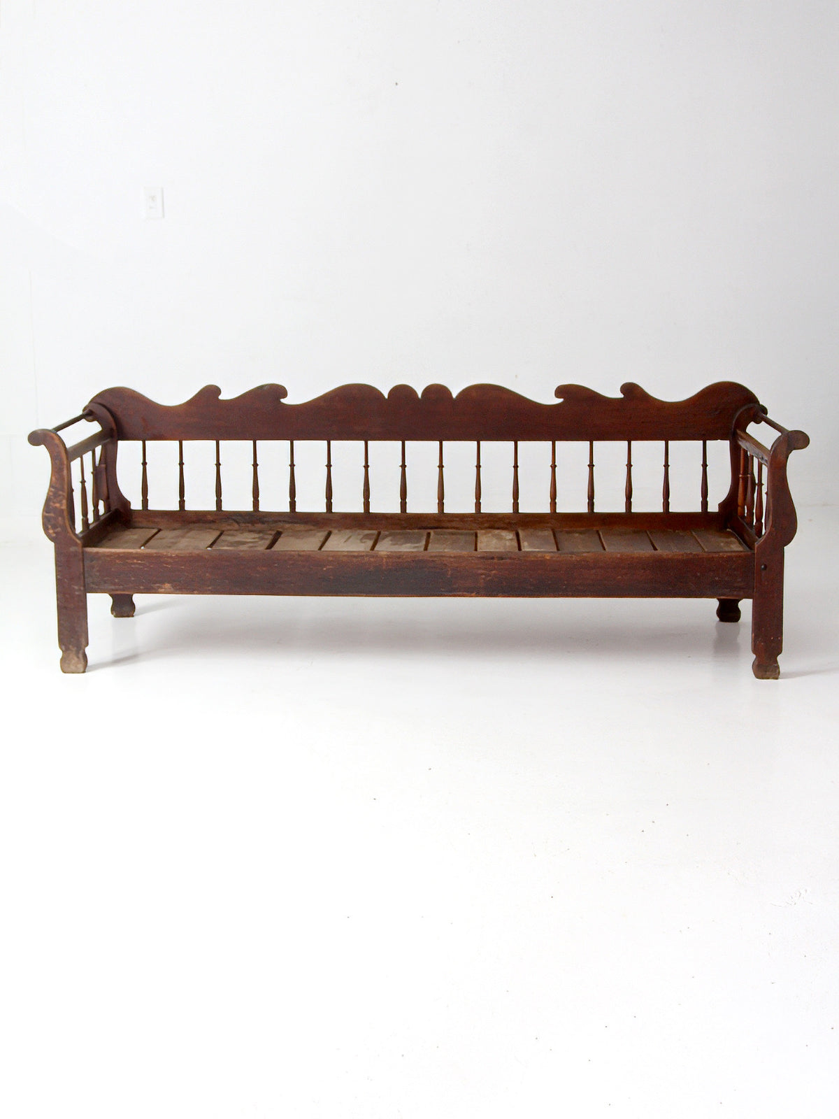 antique 19th century wooden spindle back bench with scalloped crest rail