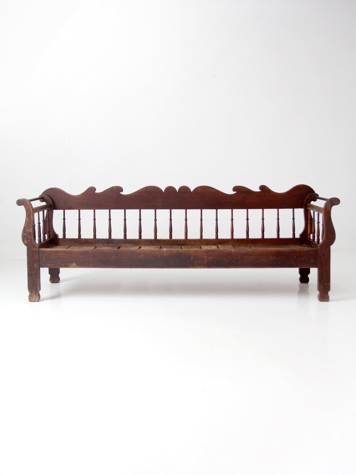 antique 19th century wooden spindle back bench with scalloped crest rail