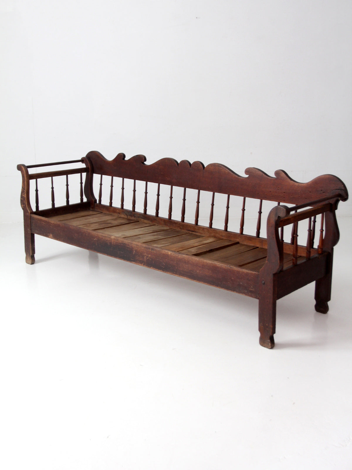 antique 19th century wooden spindle back bench with scalloped crest rail