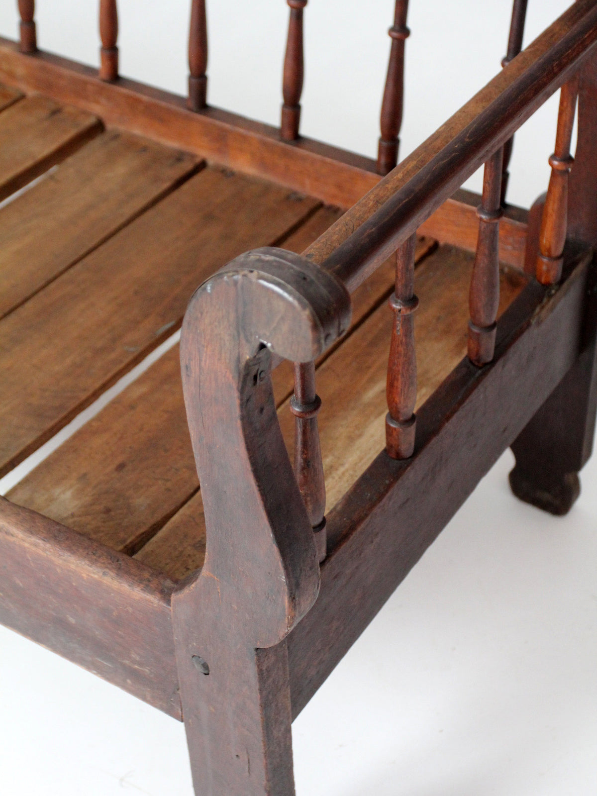 antique 19th century wooden spindle back bench with scalloped crest rail