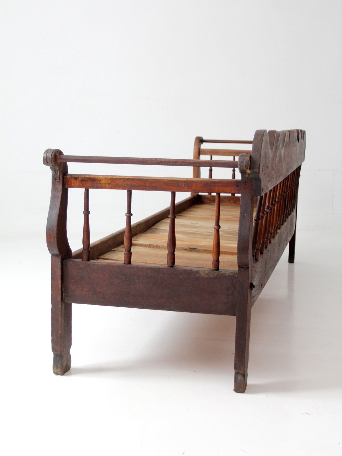 antique 19th century wooden spindle back bench with scalloped crest rail