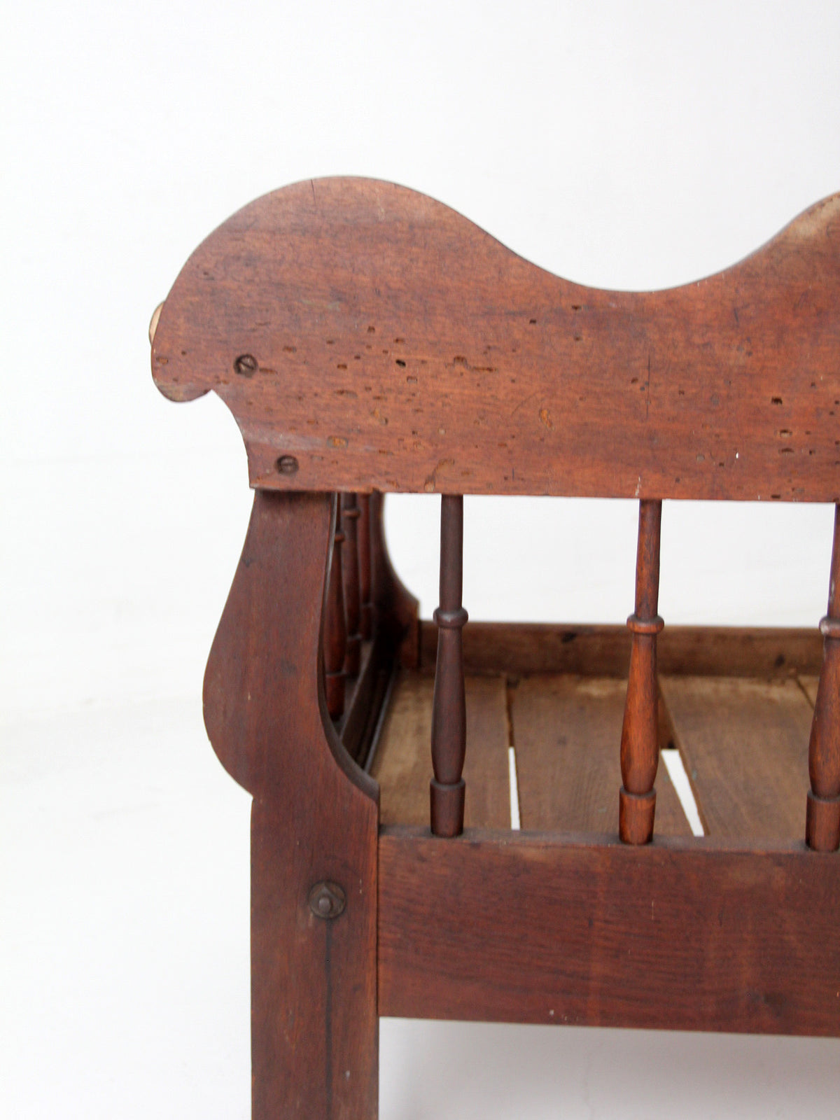 antique 19th century wooden spindle back bench with scalloped crest rail