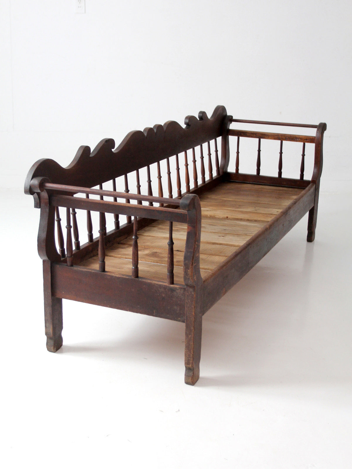 antique 19th century wooden spindle back bench with scalloped crest rail