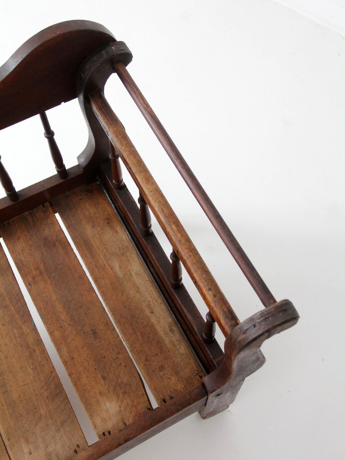 antique 19th century wooden spindle back bench with scalloped crest rail