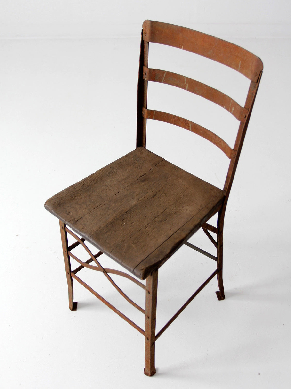 antique early 20th century riveted metal chair with wood seat