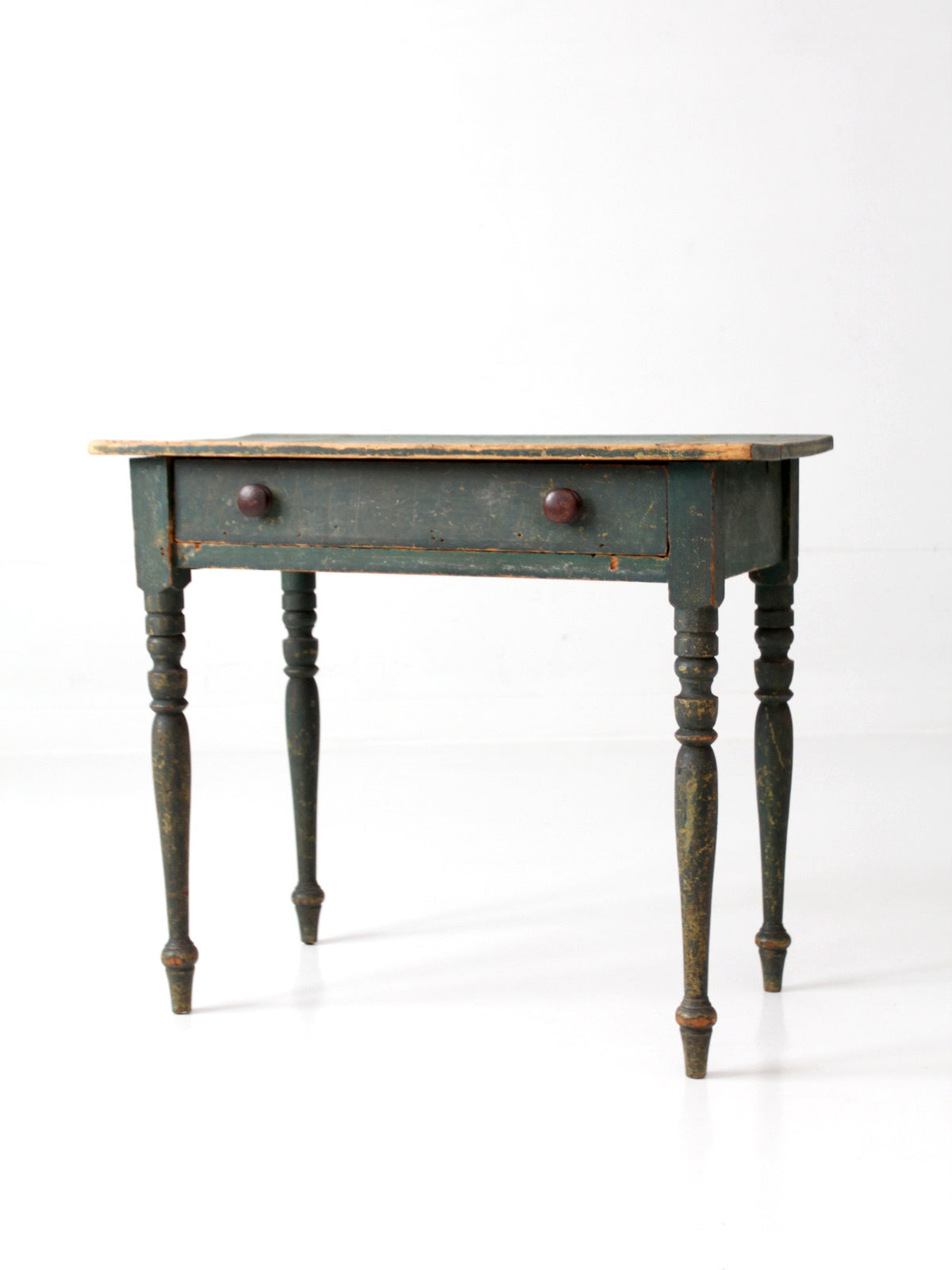 antique primitive wooden table with a single drawer on a white background