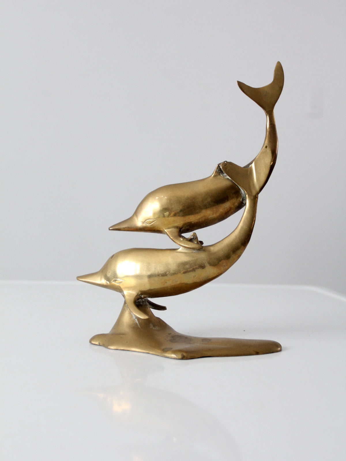 mid-century brass dolphins statue