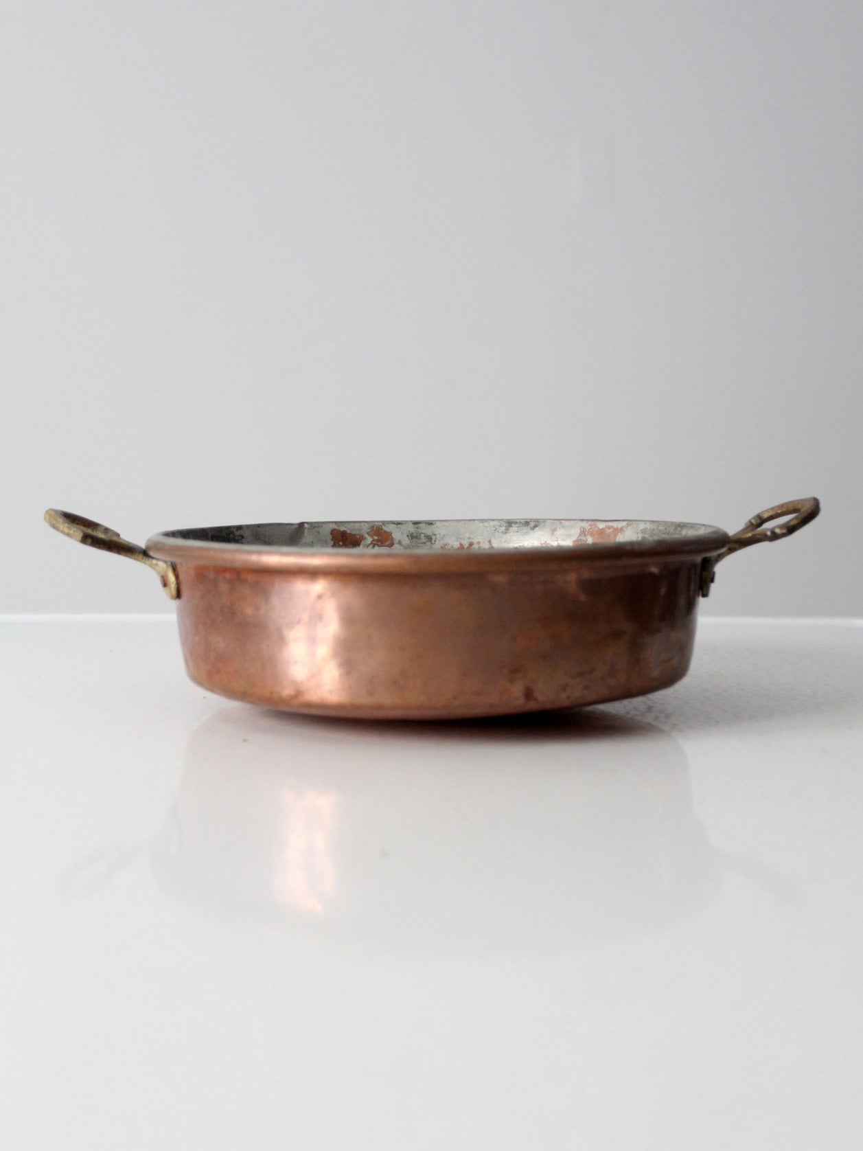 antique copper pan with brass handles
