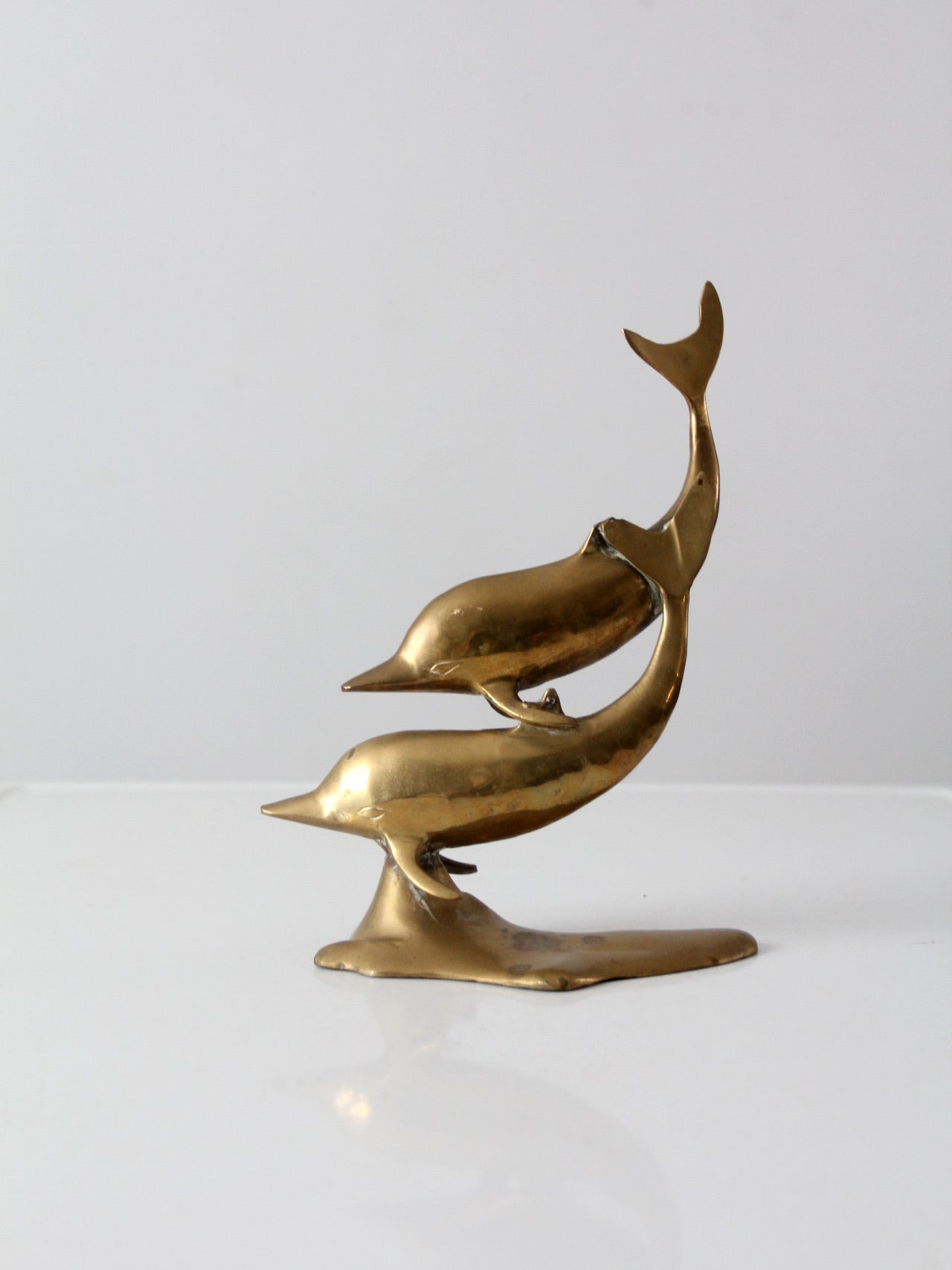 mid-century brass dolphins statue