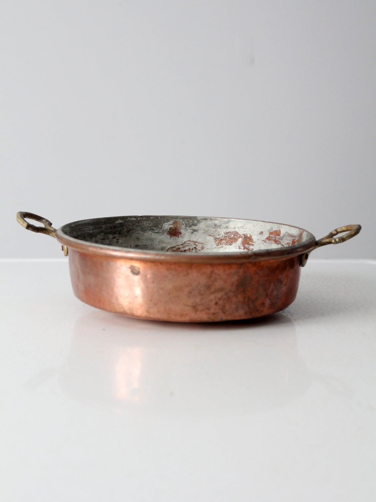 antique copper pan with brass handles