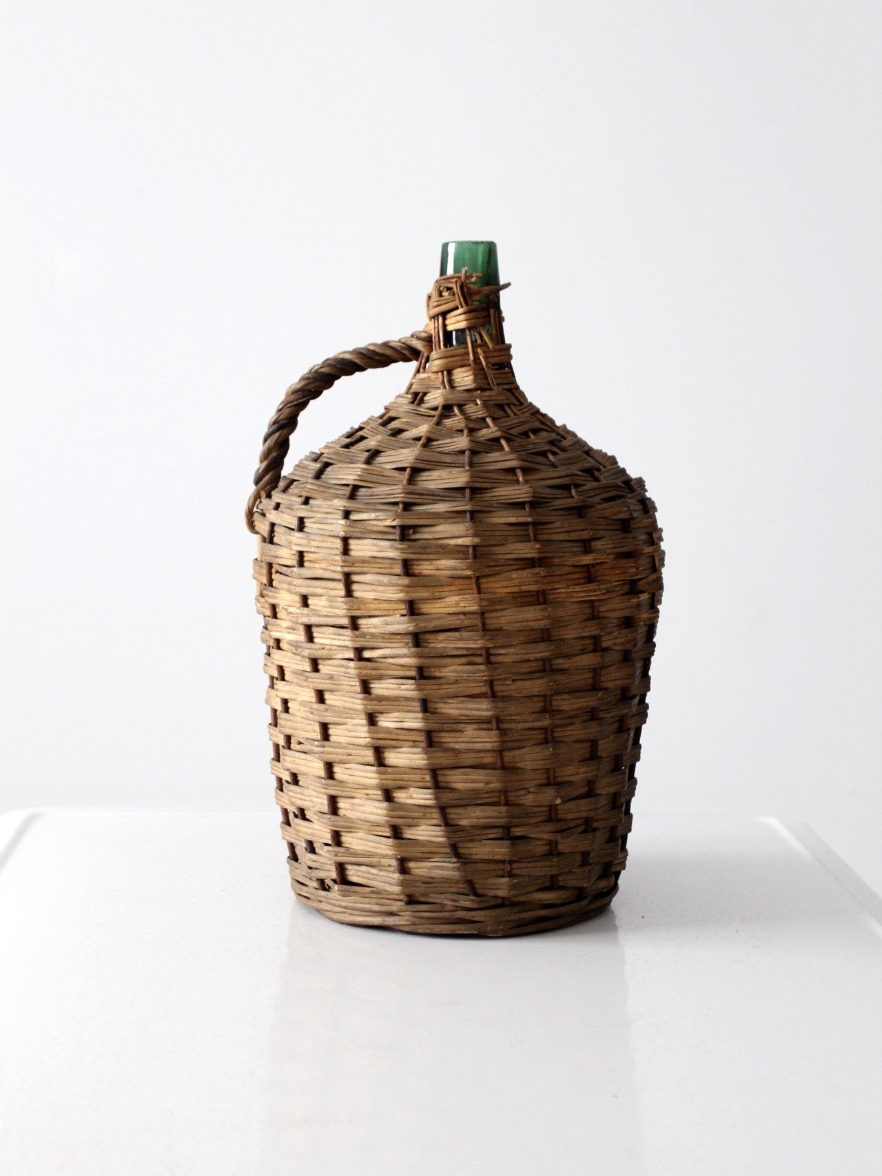 vintage demijohn with basket casing