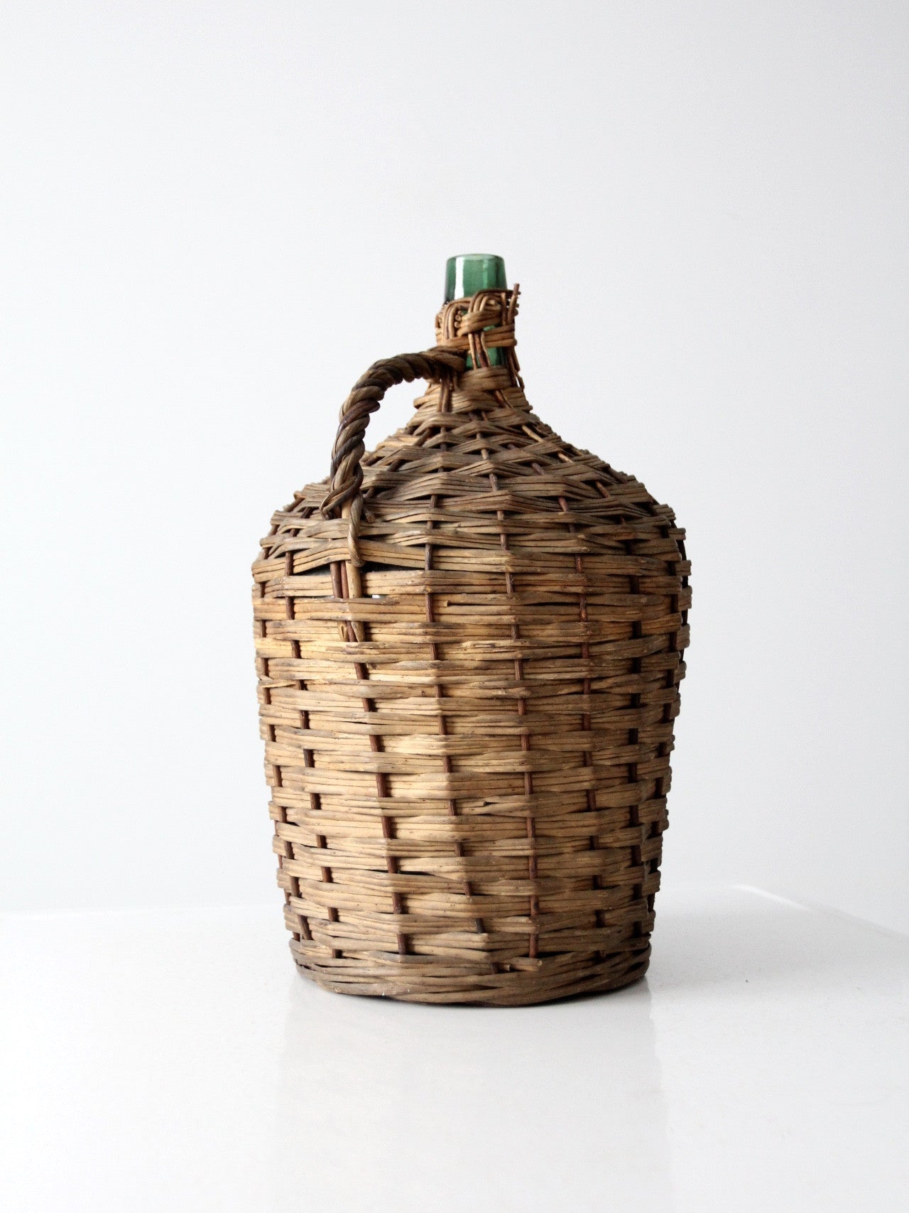 vintage demijohn with basket casing