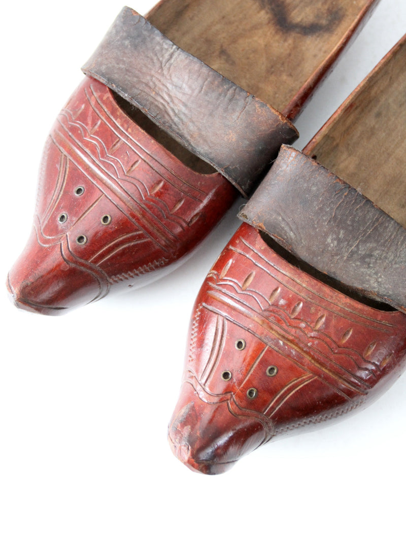 antique carved wood clogs