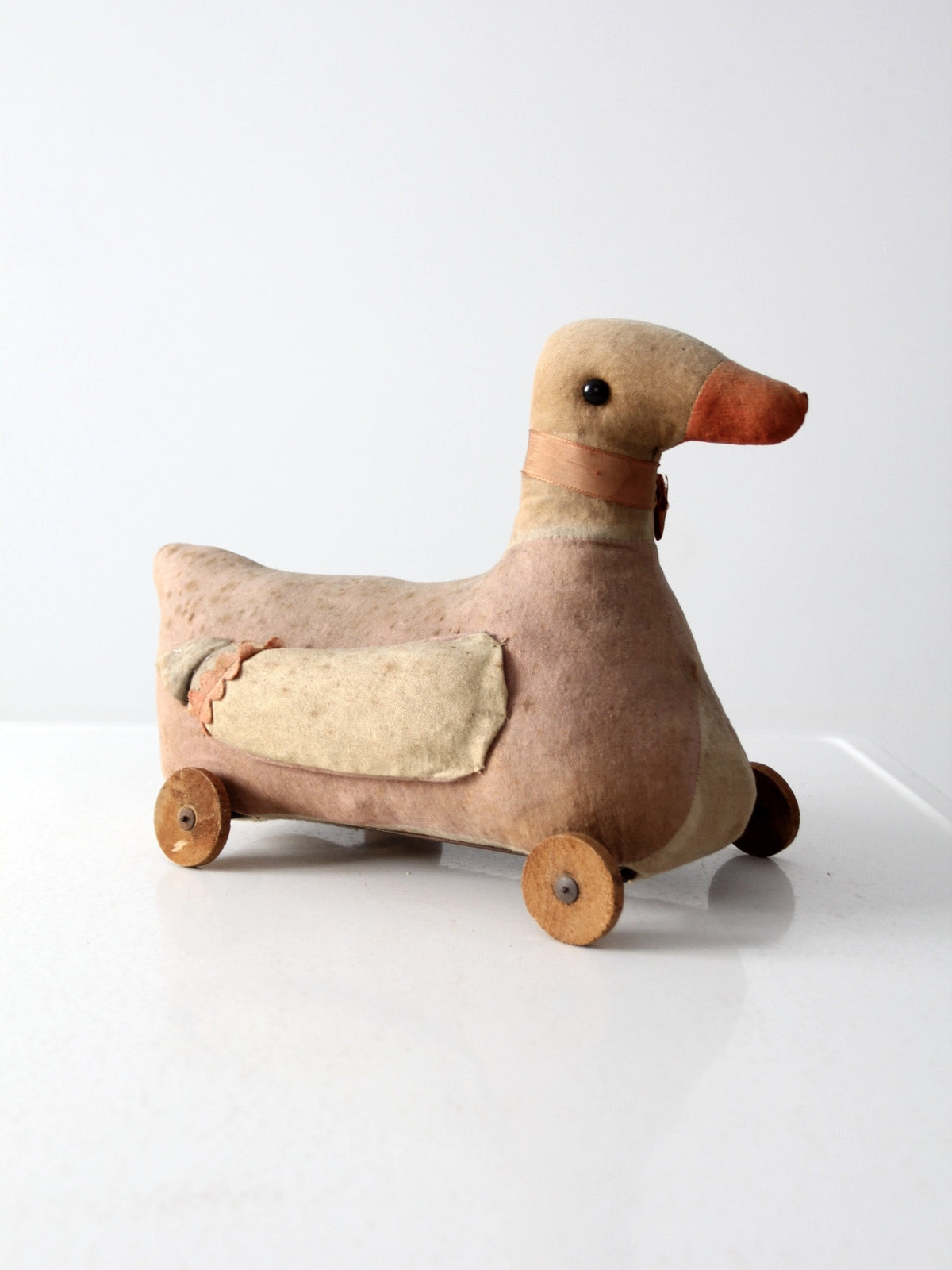 antique toy duck on wheels