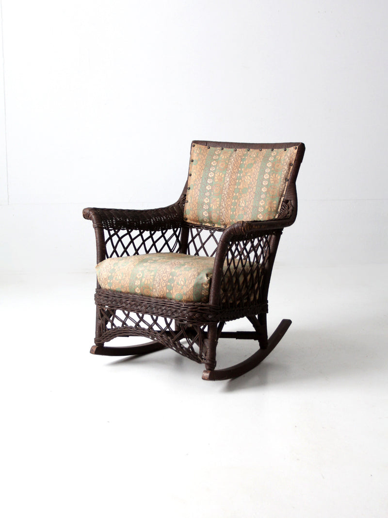 antique wicker rocking chair with cushion seat