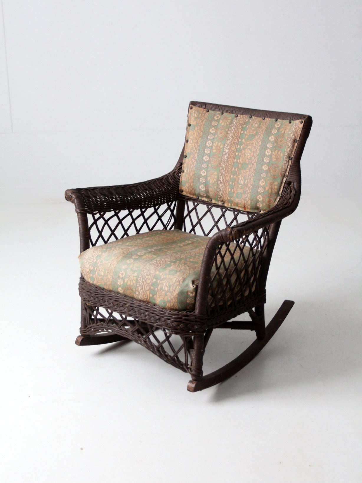 antique wicker rocking chair with cushion seat