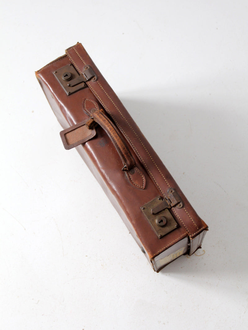 antique leather suitcase with travel stickers